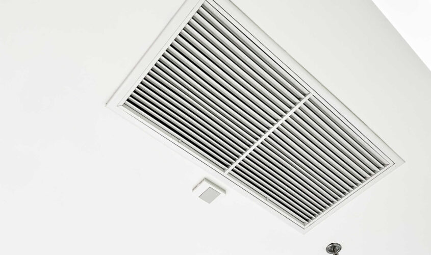 Ceiling mounted cassette type air conditioner and modern lamp light on white ceiling. duct air conditioner for home or office