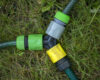 Triple connection system for watering hoses in grass