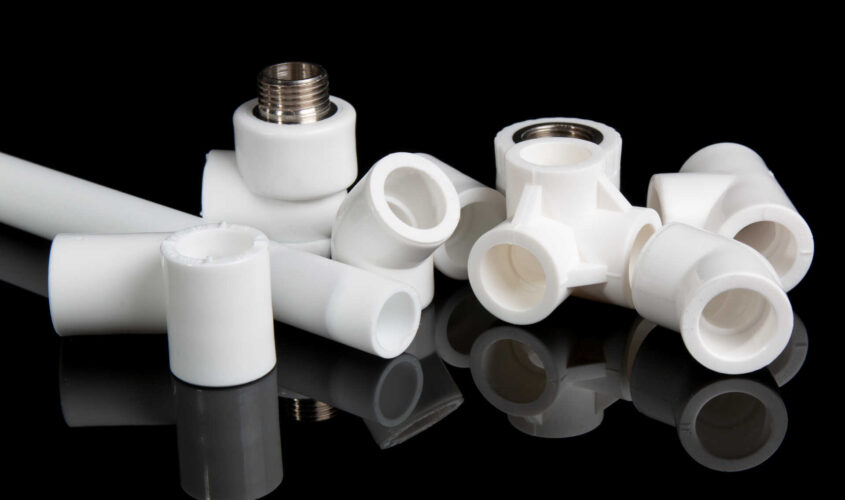 plumbing fittings for plastic pvc pipes on black background